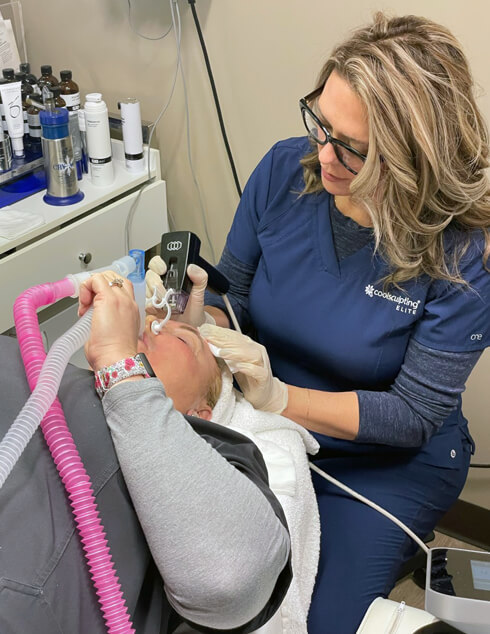 Patient receiving Morpheus8 microneedling treatment from female provider.