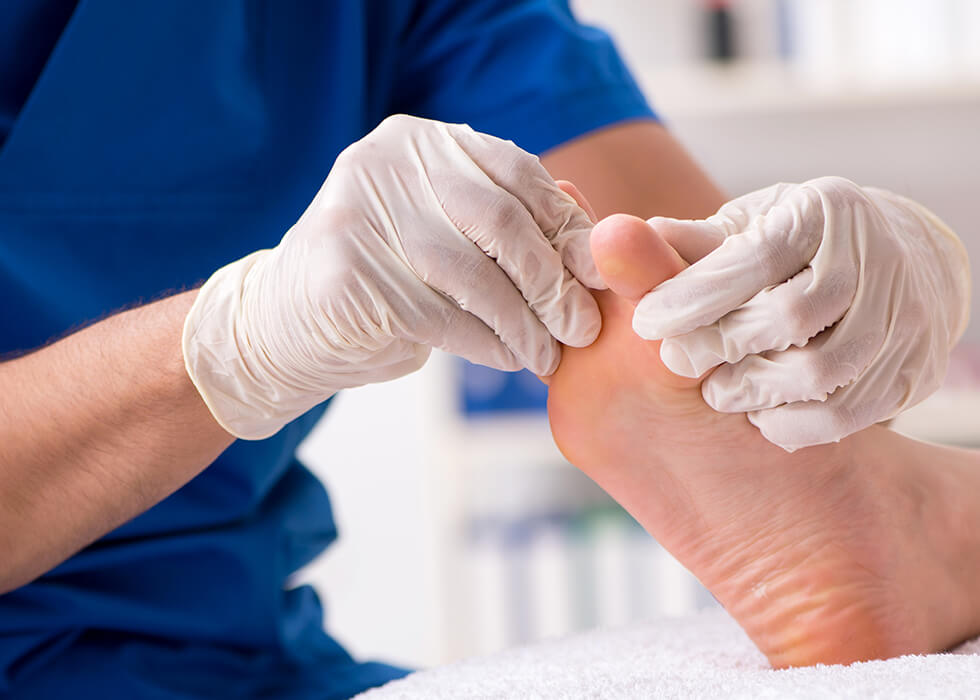 doctor assessing patients foot for calluses and corns.