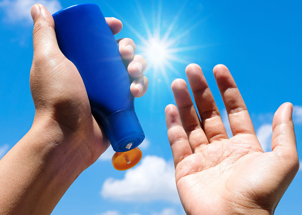 sunscreen being lifted in the sky in front of the sun.