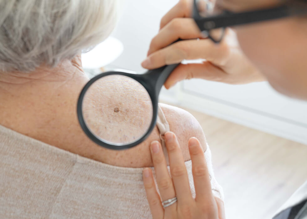 magnifying glass over woman's shoulder.