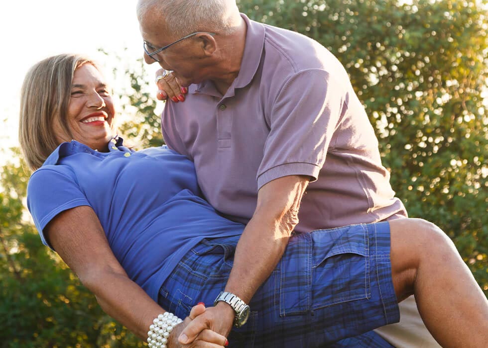 elderly couple dancing outside.