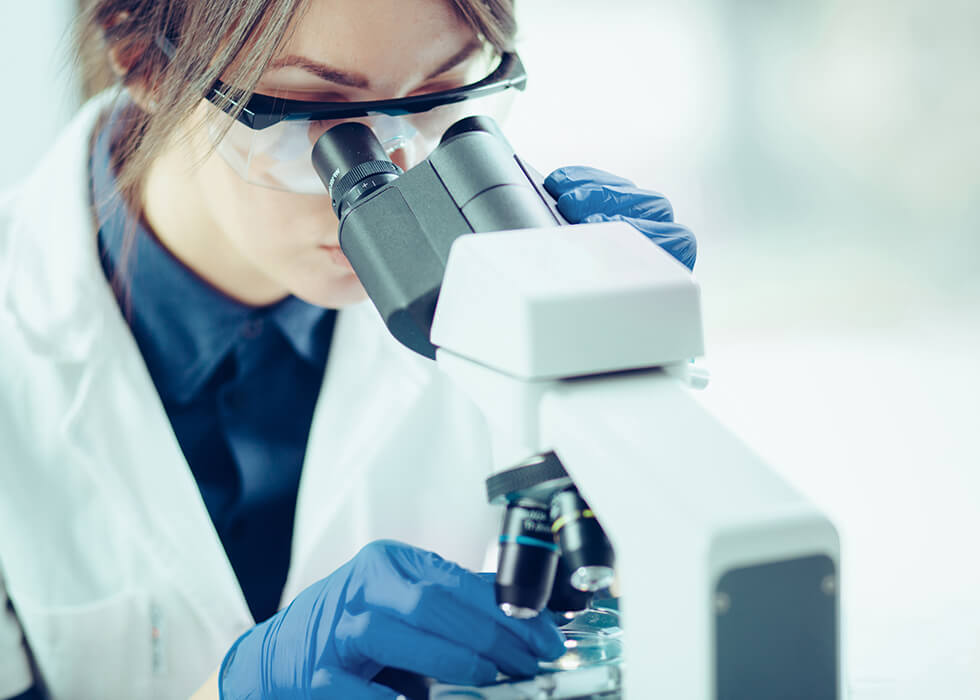 young scientist looking into microscope.